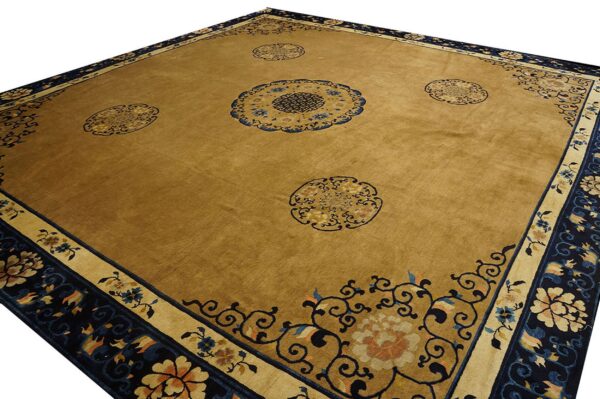 Mustard-toned rug featuring a navy blue patterned border and decorative floral medallions.