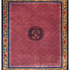 Geometric magenta rug with a central medallion and ornate gold, navy, and pink floral borders.