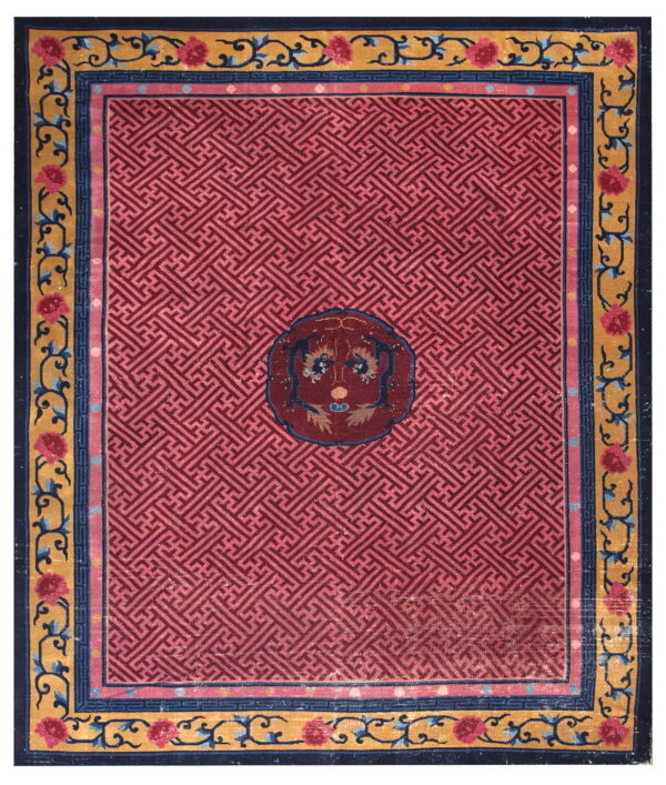 Geometric magenta rug with a central medallion and ornate gold, navy, and pink floral borders.