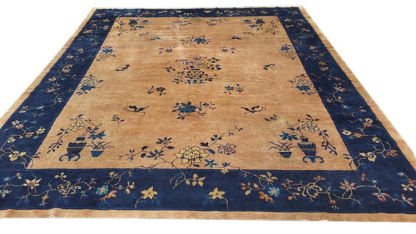 Antique chinese - peking room size wool gray rug 2 Tan traditional rug with a wide navy border featuring scattered floral and vase patterns in blue and gold.