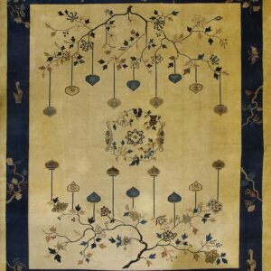 Cream and dark blue pictorial rug featuring stylized flowering branches and hanging symbolic pendants.