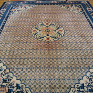 Ornate blue and pale pink rug featuring a micro-patterned field and intricate medallion rests on wooden planks.