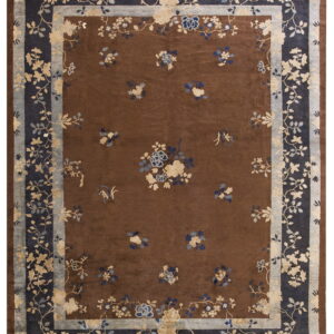 Dark brown rug featuring scattered blue and cream flowers surrounded by multi-layered navy and gray borders.