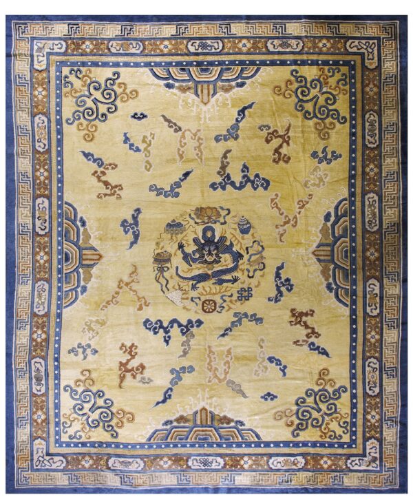 Saffron-yellow rug featuring a detailed central blue dragon and intricate blue and brown geometric borders.