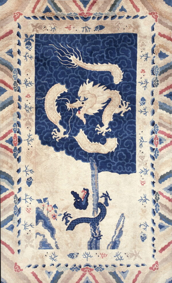 Rug with a cream dragon against a deep blue cloud background and a detailed multi-colored border.