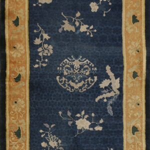 Blue runner rug featuring scattered light-colored floral patterns and a detailed mustard yellow border.