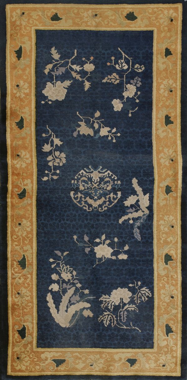 Blue runner rug featuring scattered light-colored floral patterns and a detailed mustard yellow border.
