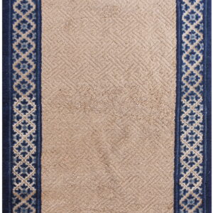 Beige runner rug featuring a subtle textured diagonal pattern framed by a detailed navy and light blue border.