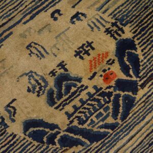Coarse pile rug detail showing blue and tan striped borders surrounding a central abstract motif with red spots.