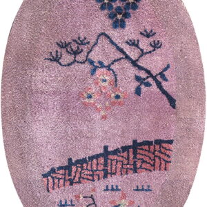 Oval mauve rug with stylized dark blue botanical designs and a horizontal geometric pattern.