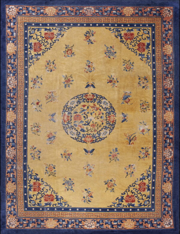 Yellow rug with detailed floral designs, a central medallion, and a wide navy blue and fretwork border.