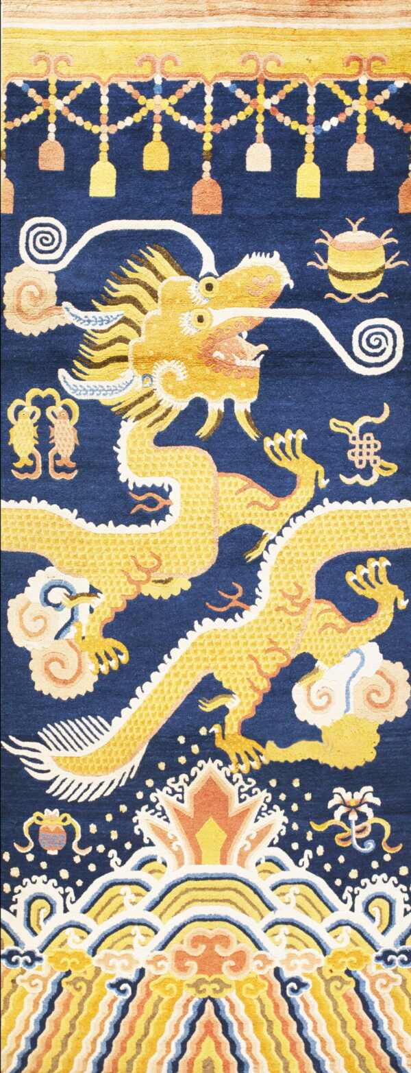 Detailed yellow dragon and clouds dominate a deep blue rug field with multicolored ornamental borders.