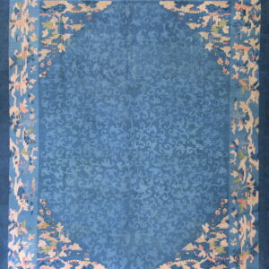 Blue rug featuring a tone-on-tone vine pattern center and an elaborate scenic landscape border in tan and pink.