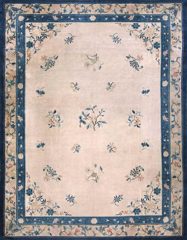 High pile rug featuring a cream field with scattered blue florals and a wide, layered dark blue border.