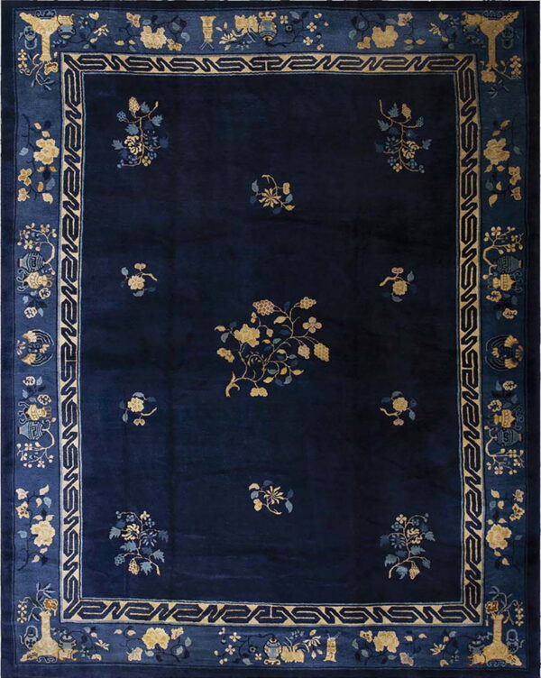 Rectangular, deep blue rug with yellow botanical motifs and a multi-layered medium blue border.