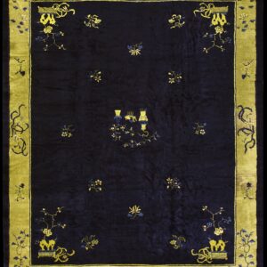 Navy rug featuring floral sprays and central vases, surrounded by a wide yellow-green border.