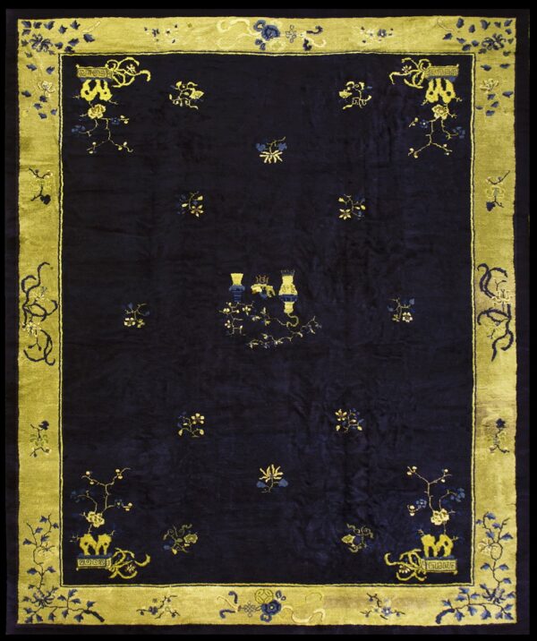 Navy rug featuring floral sprays and central vases, surrounded by a wide yellow-green border.