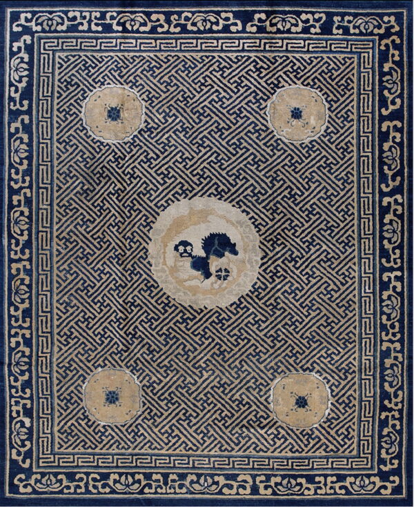 Geometric blue and tan rug with a fretwork field pattern and a decorative central animal medallion.