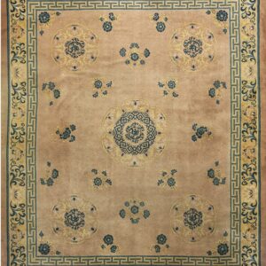 Muted pink rug featuring blue and yellow stylized floral medallions and a geometric border pattern.