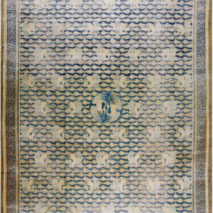 Worn blue and tan rug featuring repeating stylized bird patterns and a geometric Greek key border.