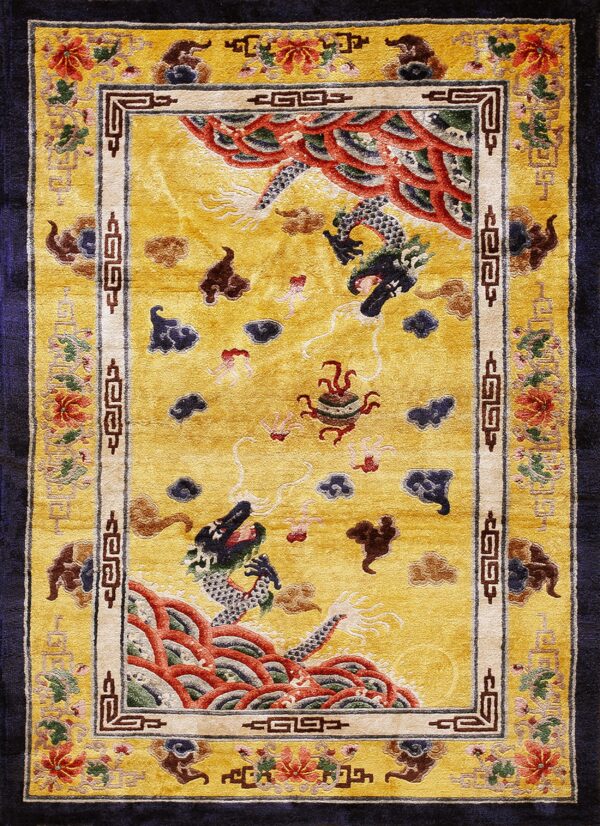 Golden yellow rectangular rug displaying dragons, clouds, and floral borders set against navy blue.