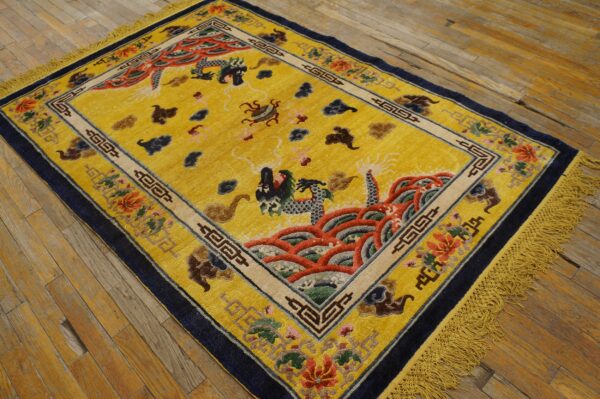 Bright yellow high-pile rug with intricate multicolored dragon and wave designs on plank wood flooring.