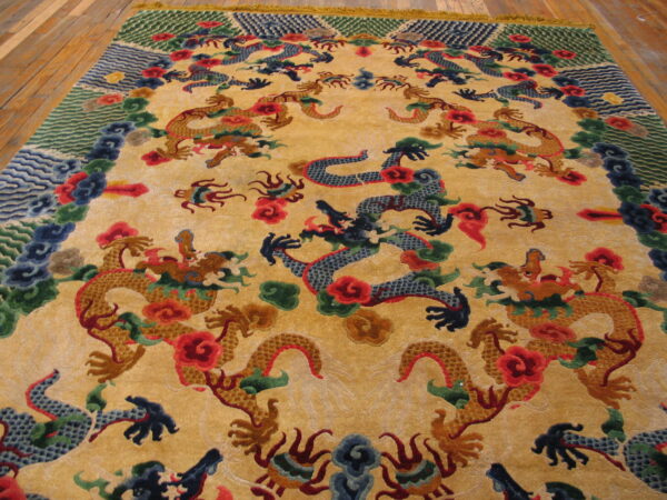 Plush yellow rug with detailed blue and gold dragon patterns and colorful borders rests on wide plank wood floors.