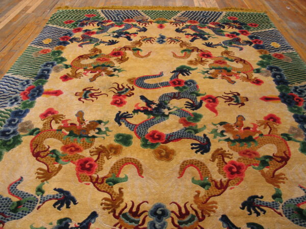 Yellow-gold rug with sculpted, colorful dragon and cloud motifs rests on light wood plank flooring.