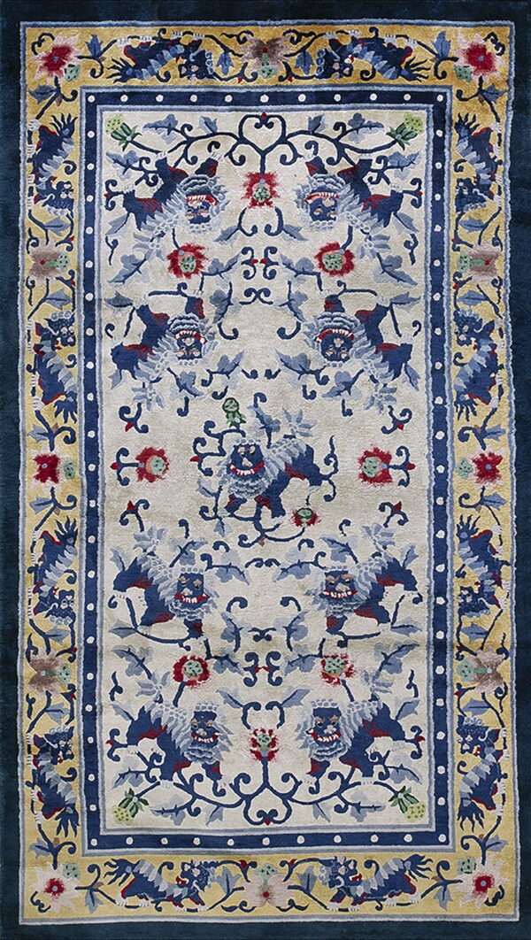Ornate area rug featuring blue animal motifs and red flowers on an ivory field with gold and dark blue borders.