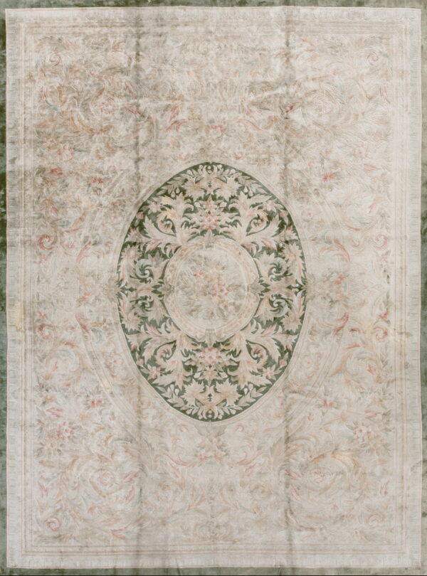 Ornate classical rug in pale cream and blush tones with a central dark green oval floral medallion.