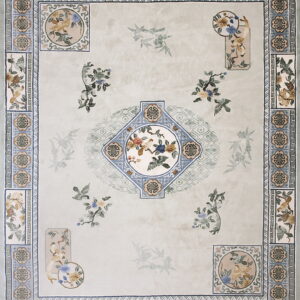 Elaborate pale sage rug with detailed blue borders and central bird and flower medallions.