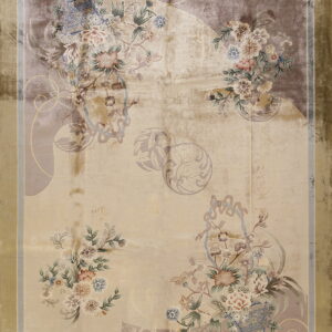 Low-pile rug with a shimmering beige field, muted floral clusters, and a wide golden olive green border.