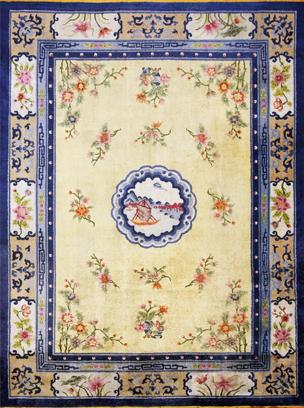 Light yellow rug featuring scattered florals and a scenic medallion within detailed navy and tan borders.