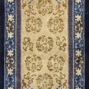 Beige and brown floral rug featuring intricate borders in multiple shades of blue.