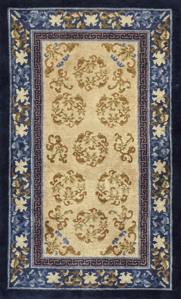 Beige and brown floral rug featuring intricate borders in multiple shades of blue.