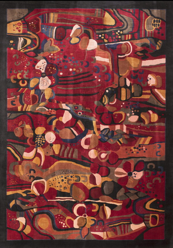 Sculpted abstract area rug in red, gold, black, and brown with large organic shapes.