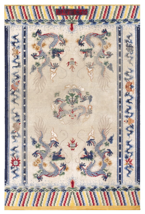 Cream rug featuring multiple blue dragon motifs and elaborate borders with stripes of red, yellow, and blue.