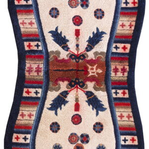 Plush, hourglass-shaped rug with a cream center, blue fish, and striped geometric red and navy borders.