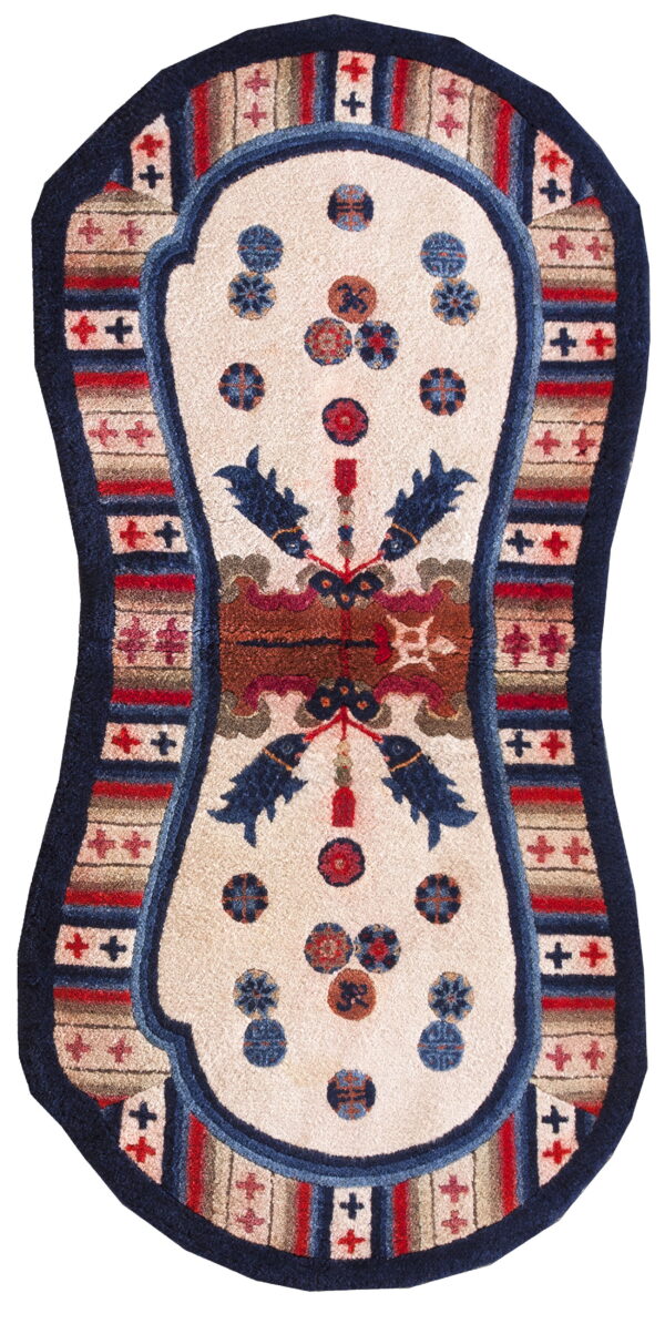 Plush, hourglass-shaped rug with a cream center, blue fish, and striped geometric red and navy borders.