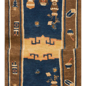 Stepped blue rug with a brown border, stylized vessel pattern, and a visible hole in the blue pile.