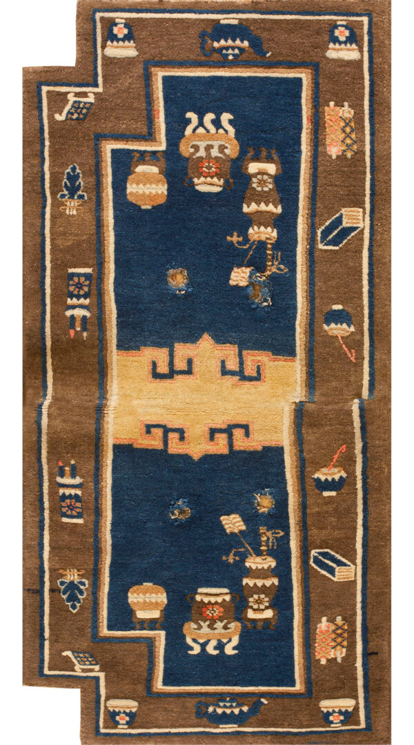 Stepped blue rug with a brown border, stylized vessel pattern, and a visible hole in the blue pile.