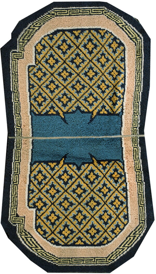 Octagonal rug with navy and gold geometric diamond field and a central teal panel, bordered by beige.