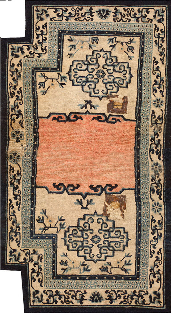 Medium pile rug with indigo, blue, and cream borders framing a solid textured salmon-pink center band.
