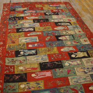 Multicolored textile featuring detailed embroidered figures and florals set in a repeating rectangular grid on wood.