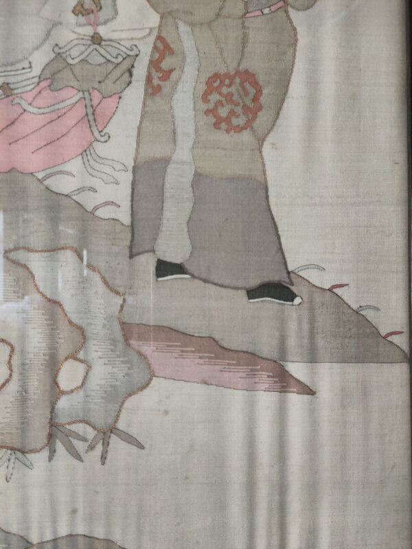 Detailed textile showing gray robes, black shoes, pink garments, and abstract rust patterns on an off-white background.