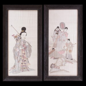 Framed pair of panels display detailed figures in soft gray, pink, and mauve embroidery on pale fabric.