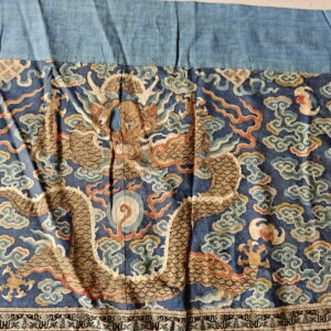 Low-pile textile in dark blue with a large metallic gold dragon and swirling rust and light blue clouds.