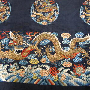 Navy textile with an ornate golden dragon, multicolored swirling clouds, and detailed ocean wave border.