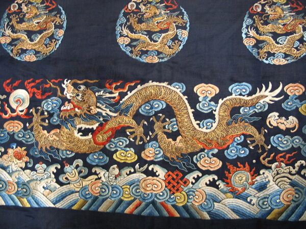 Navy textile with an ornate golden dragon, multicolored swirling clouds, and detailed ocean wave border.