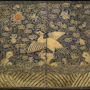 Blue rug with dense gold patterning featuring a large winged bird, sun disc, clouds, and waves.